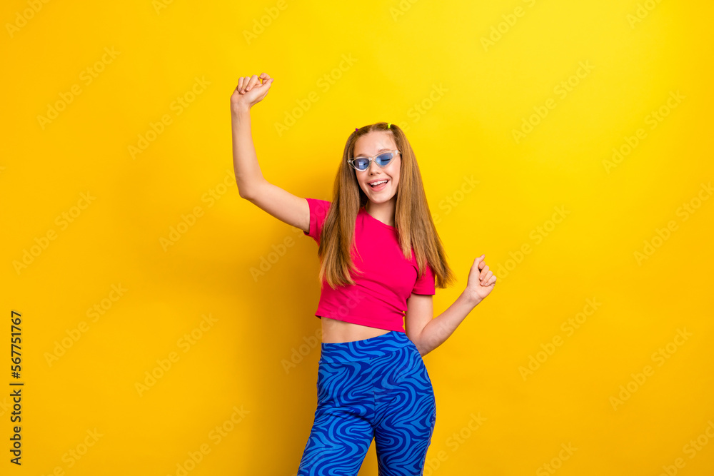 Photo of relaxed overjoyed girl teenager wear stylish new sunglasses chilling listen music lover dancing have fun isolated on yellow color background Photo of relaxed overjoyed girl teenager wear stylish new sunglasses chilling listen music lover dancing have fun isolated on yellow color background