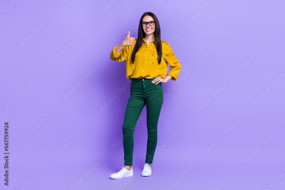 Full size portrait of charming positive girl show thumb up yes quality isolated on purple color background Full size portrait of charming positive girl show thumb up yes quality isolated on purple color background