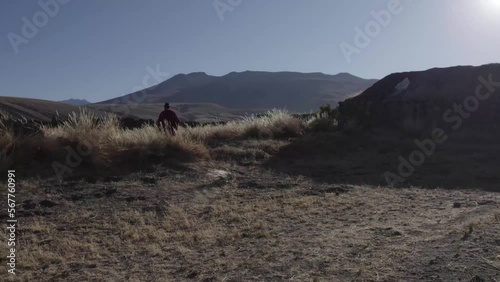 hombre campesino saliendo de su casa en un amanecer  camino a la montaña  photo