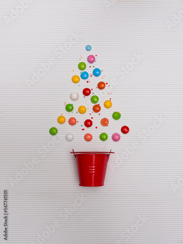 Conceptual multi coloured Christmas tree made from a bucket and confectionery photo