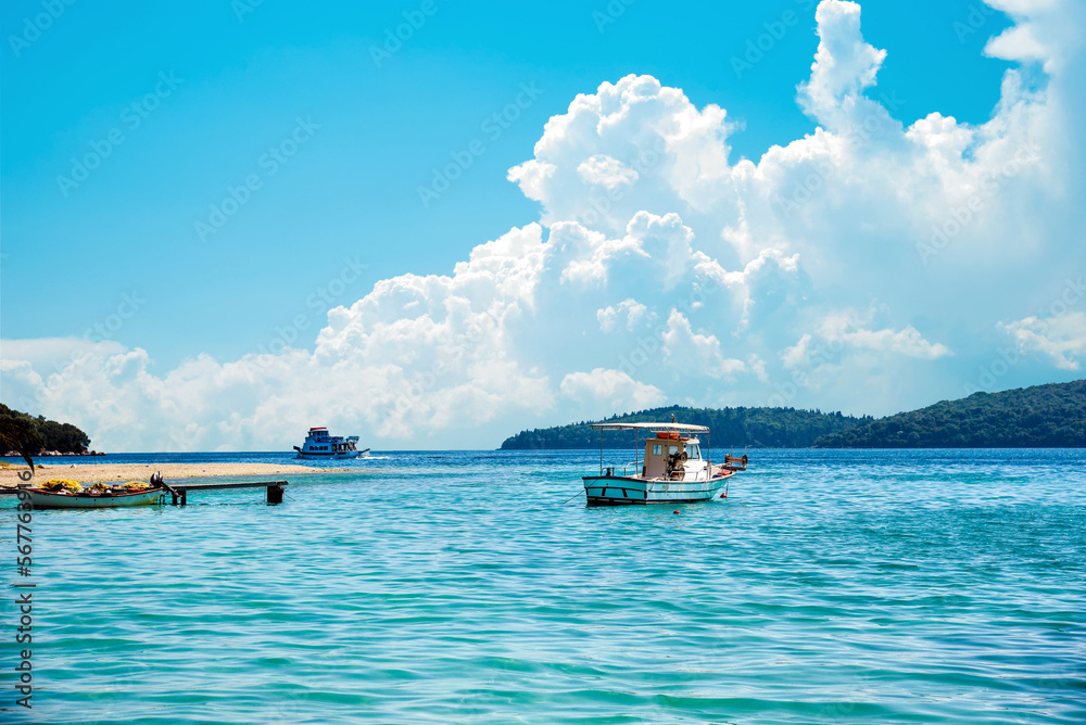 Beautiful scenic landscape with a boat in the bay and a wooden pier near Nydri, Lefkada, Greece