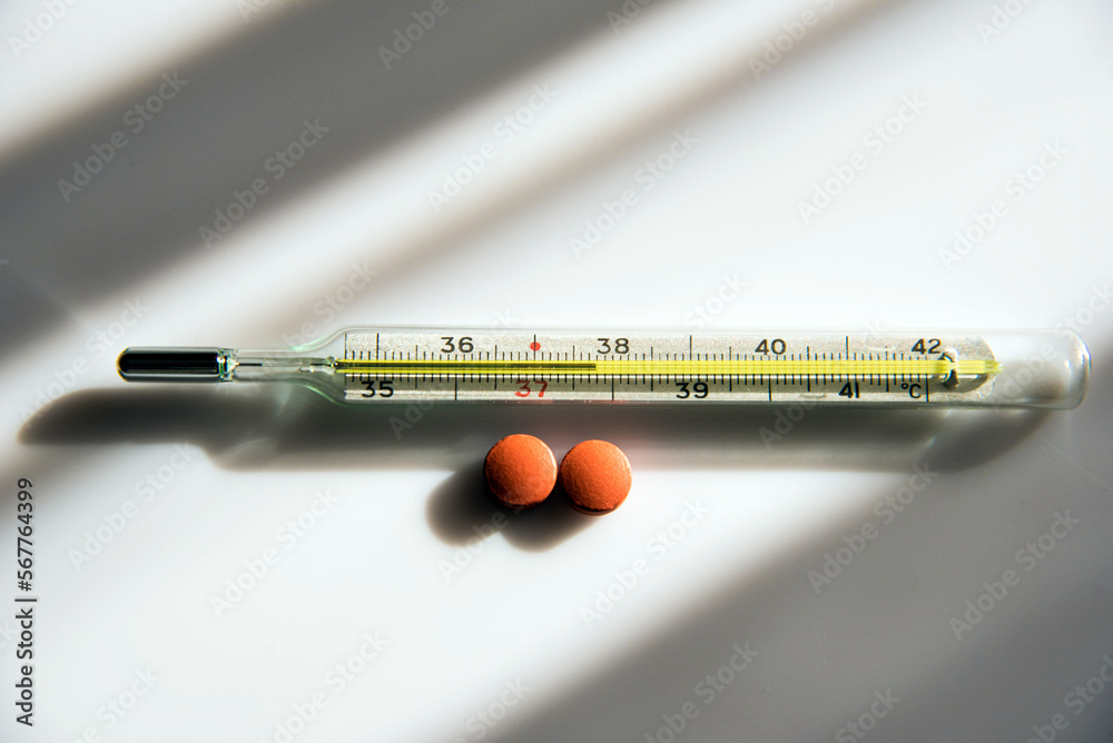 Abstract image of a thermometer with high temperature and medication (Сovid - concept).