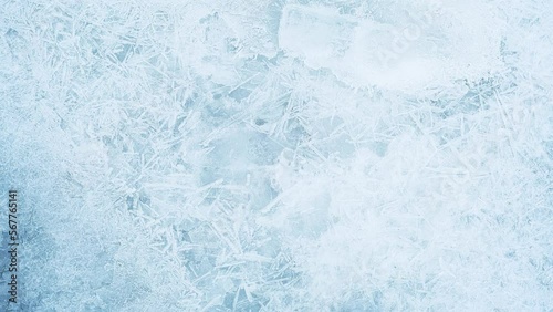 Texture of ice on the frozen lake. Blue color background.