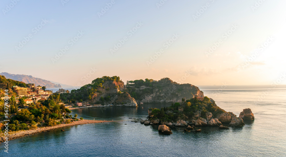 amazing view to a rocky coast and beautiful isle in sea with nice coasline and clouds on the background of the evening sea landscape