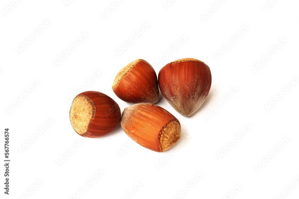 Hazelnuts isolated on white background. A pile of delicious and healthy hazelnuts isolated on a white background. Healthy food and cooking concept. Hazelnuts isolated on white background. A pile of delicious and healthy hazelnuts isolated on a white background. Healthy food and cooking concept.