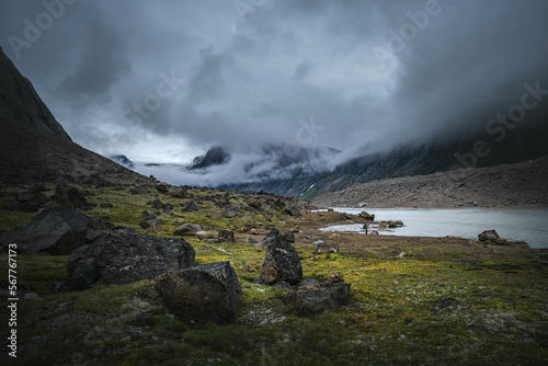 Hiking in wild, remote arctic valley of Akshayuk Pass, Baffin Island, Canada photo