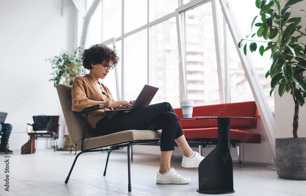 Millennial woman working in open space office Millennial woman working in open space office