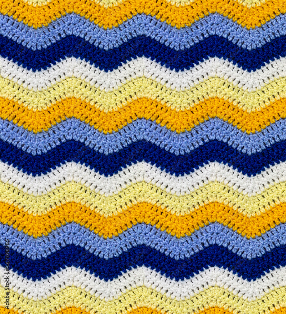 Seamless knitted pattern in the form of zigzags crocheted with threads of contrasting colors. Acrylic baby yarn. African style.