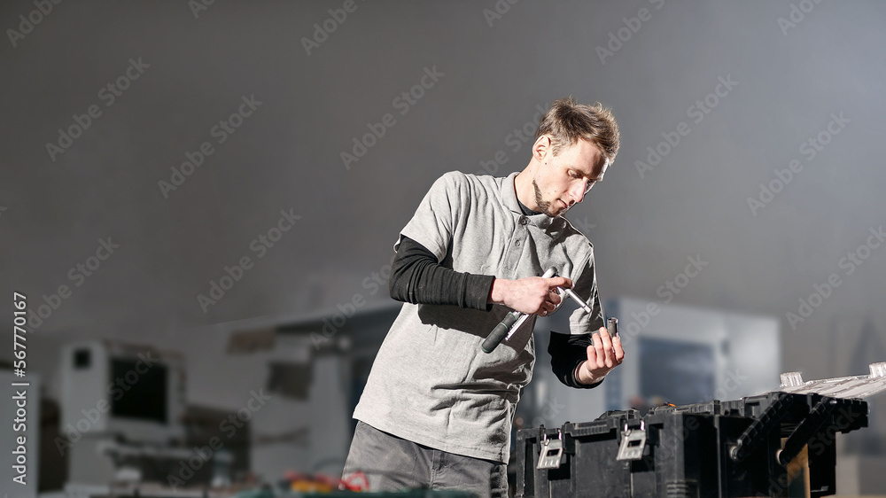 A young employee working in the furniture industry. Service maintenance of furniture production A young employee working in the furniture industry. Service maintenance of furniture production