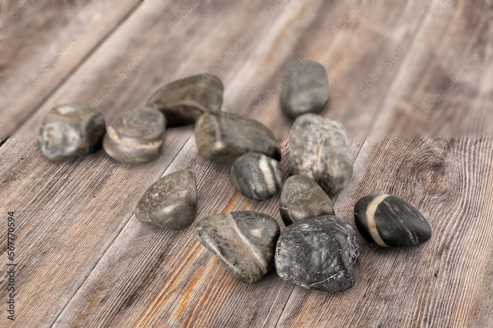 Rocks, natural stones pile on wooden desk Rocks, natural stones pile on wooden desk