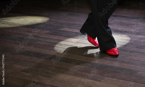 Close-up of a male tango dancer's legs in a ballroom photo