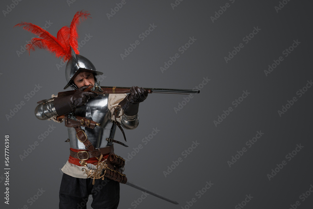Studio shot of french rifleman dressed in plate armour aiming flintlock rifle. Studio shot of french rifleman dressed in plate armour aiming flintlock rifle.