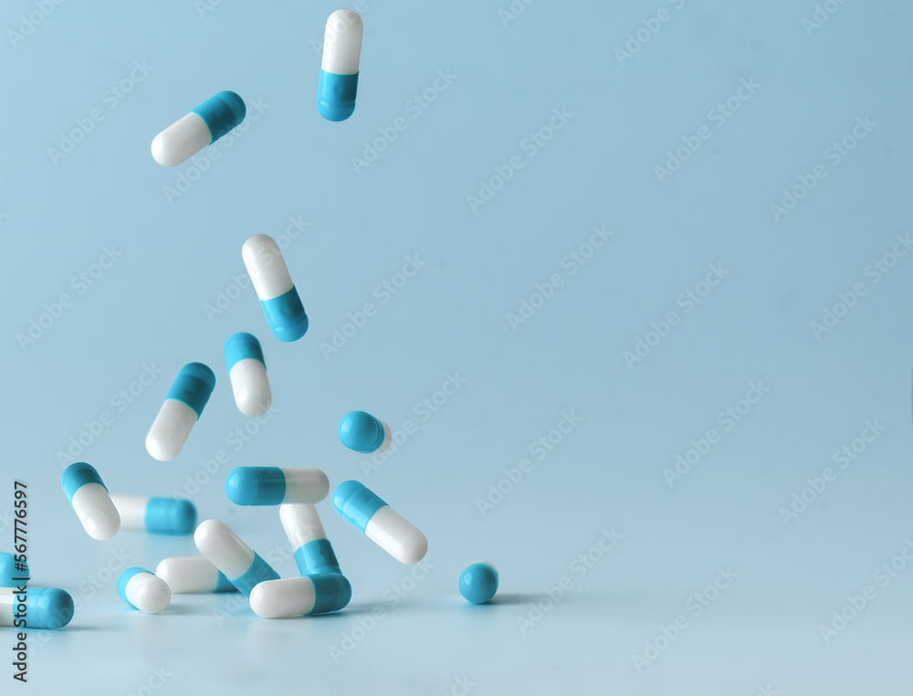 Falling blue white capsules on blue background. Falling blue white capsules on blue background.