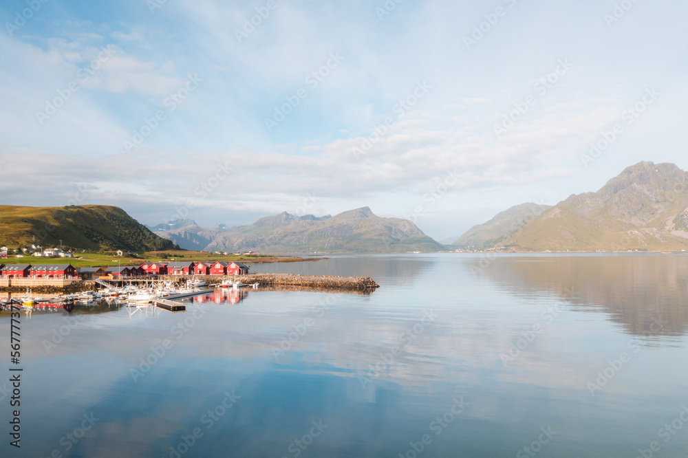 Lofoten islands in Norway at sunrise. Aerial drone view of fjords on a sunny day with water reflections