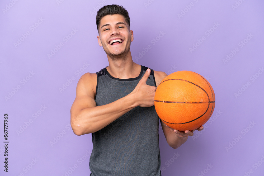 young caucasian woman  basketball player man isolated on purple background giving a thumbs up gesture