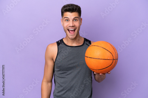 young caucasian woman basketball player man isolated on purple background with surprise facial expression