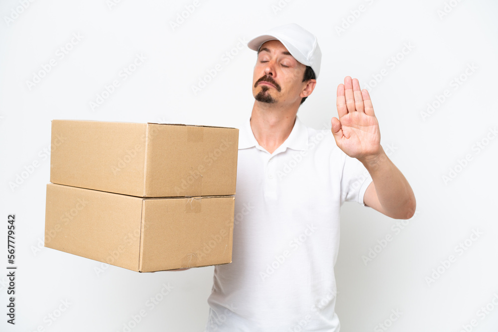 Delivery caucasian man isolated on white background making stop gesture and disappointed Delivery caucasian man isolated on white background making stop gesture and disappointed