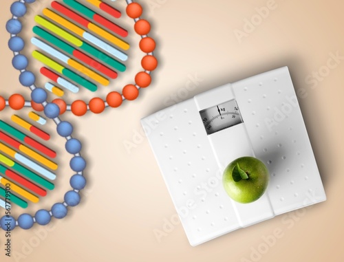 DNA structure, sport dumbbells and tape measure on desk photo