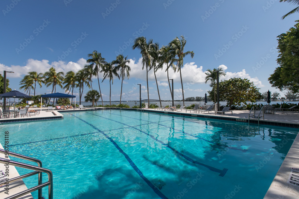 Large commercial swimming pool overlooking ocean.