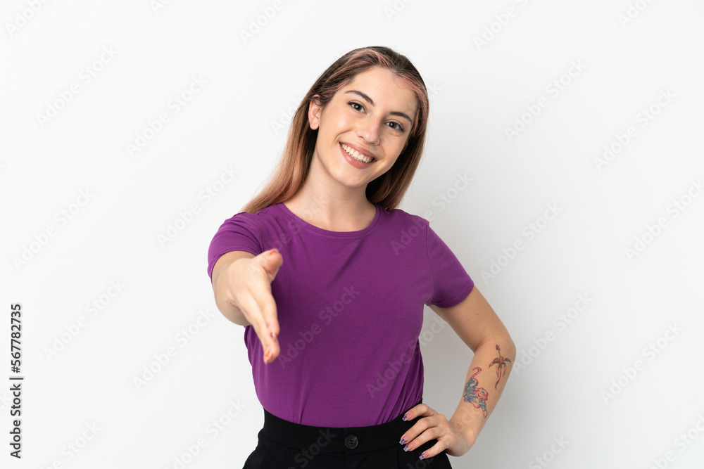 Young caucasian woman isolated on white background shaking hands for closing a good deal