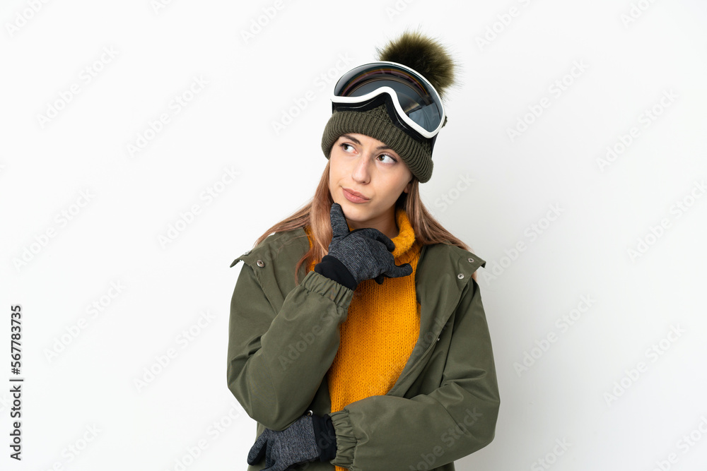 Skier caucasian woman with snowboarding glasses isolated on white background and looking up Skier caucasian woman with snowboarding glasses isolated on white background and looking up