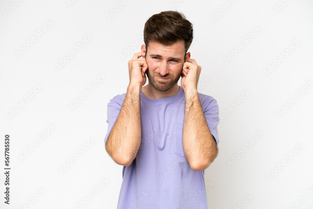 Young caucasian man isolated on white background frustrated and covering ears Young caucasian man isolated on white background frustrated and covering ears