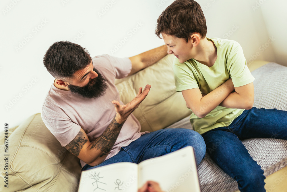 Internet addicted boy visiting therapist with his father Internet addicted boy visiting therapist with his father