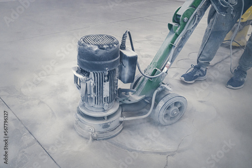 Sanding a concrete floor before painting with epoxy industrial paints