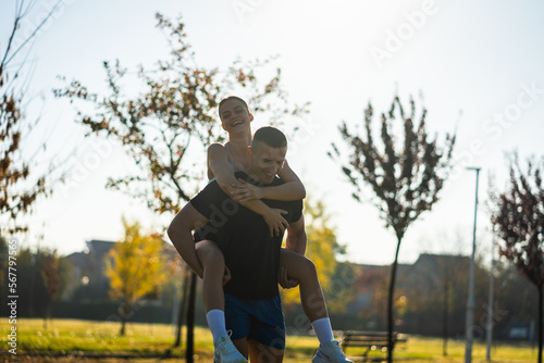Male sports person giving a piggyback to his girl