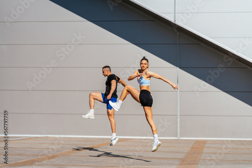 Couple jumping. Warming up before training