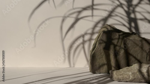 Stone Podium for promotion on beige Background. Natural pedestal. Podiums with leaf shadow. Beauty product mockup.Front View. Scene to show products. Showcase, display case.Trendy sunlight.