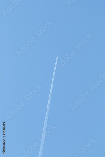 high in the blue sky the trail of an airplane