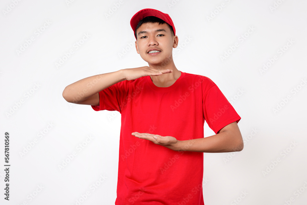 Courier Delivery worker shipping concept. Smiling young asian Delivery man in red uniform isolated on white background gesturing with hands showing size illustration Courier Delivery worker shipping concept. Smiling young asian Delivery man in red uniform isolated on white background gesturing with hands showing size illustration