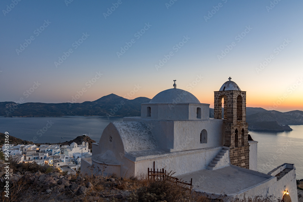 Panoramic view on Plaka village and the bay from the Venetian castle at dusk, Milos island GR	