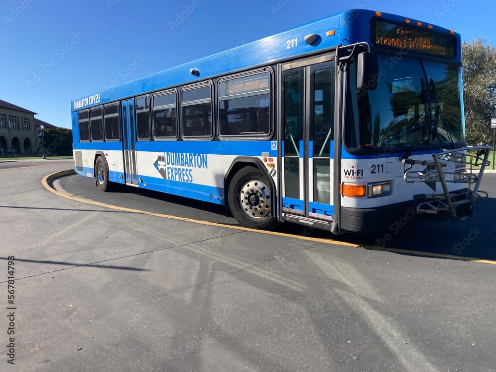 Dumbarton Express bus waits for passengers at the bus stop. Front, side