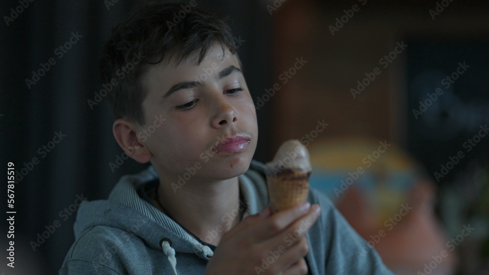 A teen kid eating ice cream young boy enjoying summer dessert A teen kid eating ice cream young boy enjoying summer dessert
