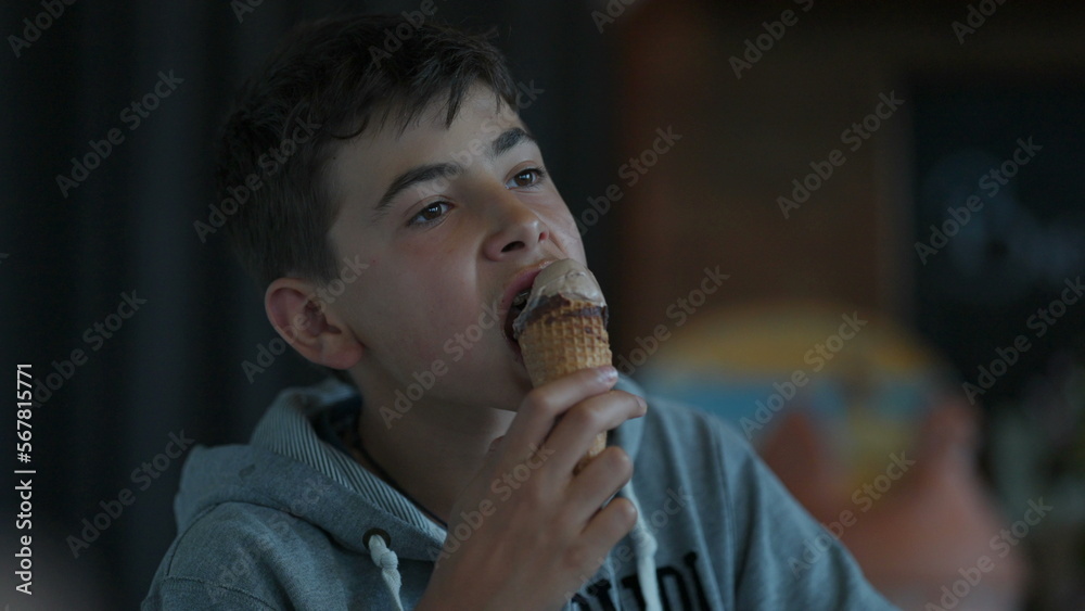 A teen kid eating ice cream young boy enjoying summer dessert A teen kid eating ice cream young boy enjoying summer dessert