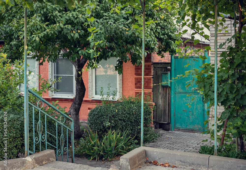 A picturesque approach to a one-story red brick house with a refined facade. A picturesque approach to a one-story red brick house with a refined facade.