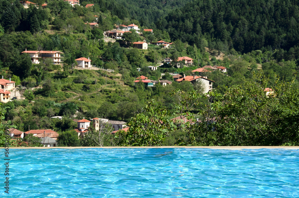 Swimming pool with great view to the mountain and village. Exotic vacations. Greece