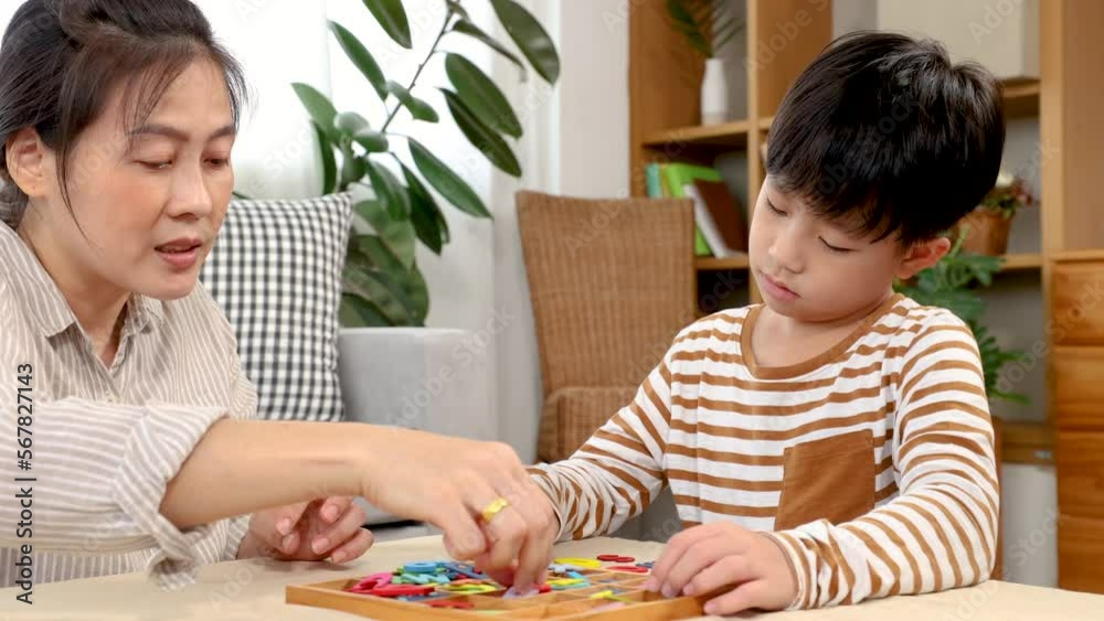 Asian happy single mother and son playing alphabet games with plastic toys, mom helping child learn foreign language for improve mental health and memory. family spending time together in holiday.
Asian happy single mother and son playing alphabet games with plastic toys, mom helping child learn foreign language for improve mental health and memory. family spending time together in holiday.