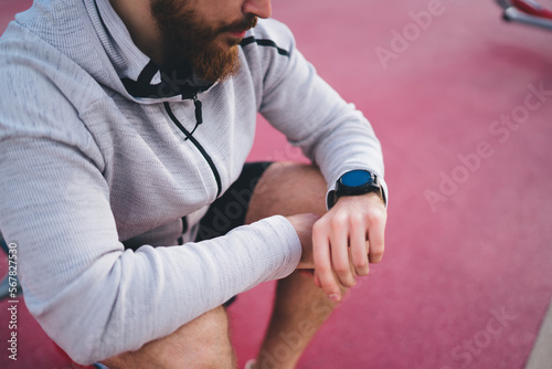 Man checking notifications on smart watch during outdoor training