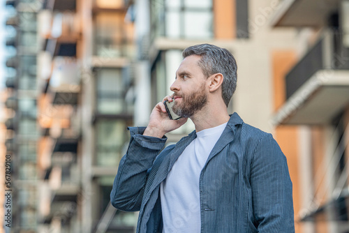 mature man call on mobile outside. photo of man call on mobile phone. man has mobile call