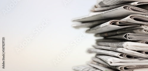 A pile of dusty, old magazines on background
