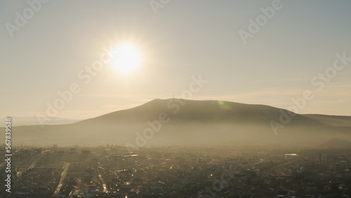 Landscape view of Uçhisar, Cappadocia Turkey. During sunset, haze above it. One of the most touristic villages in Turkey. Selective focus.