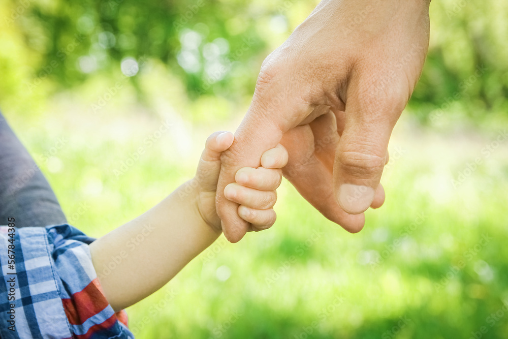 the parent holding the child's hand with a happy background