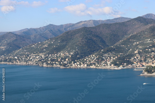 Camogli, Italy - January 28, 2023: An aerial view to the city of Camogli. Beautiful landscape from the ligurian sea with blue sky and mountains in the background. 