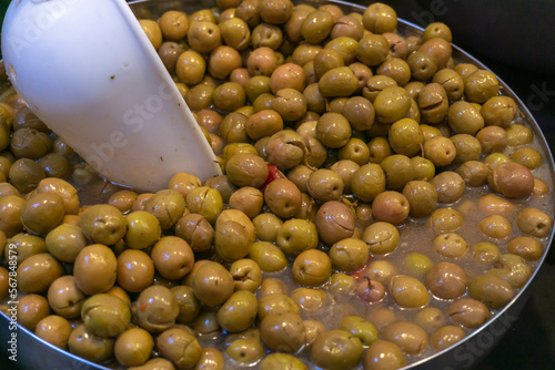 Stand of olives in bulk close-up of green olives