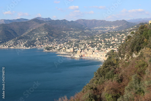 Fototapeta Naklejka Na Ścianę i Meble -  Camogli, Italy - January 28, 2023: An aerial view to the city of Camogli. Beautiful landscape from the ligurian sea with blue sky and mountains in the background. 