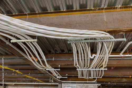 Installation of assembled electrical wires in ceilings of a newly constructed apartment complex was carried
