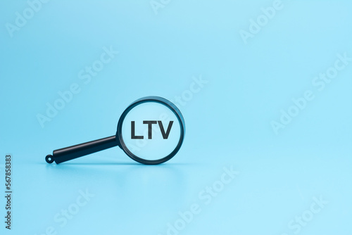 look at the text LTV through a magnifying glass on a blue background